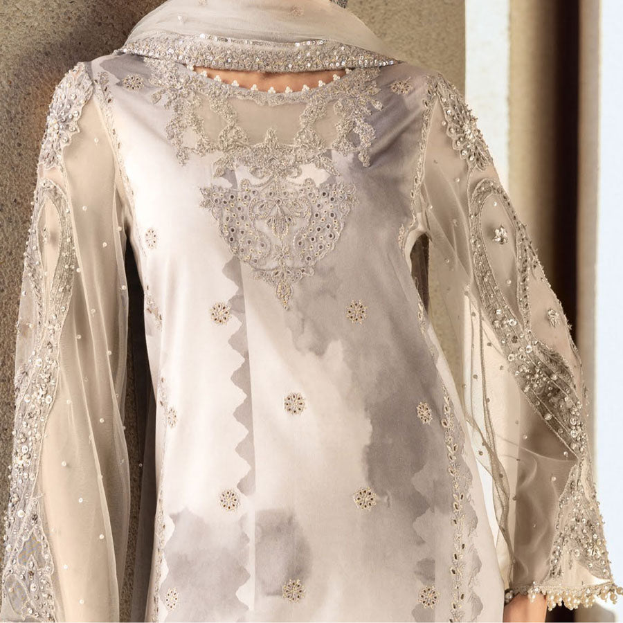 Charizma Festive Unstitched Collection 2025 – Two models wearing elegant embroidered Pakistani suits in pastel blue and golden yellow, featuring intricate handwork, sequins, and delicate embellishments, perfect for Eid celebrations and festive occasions.