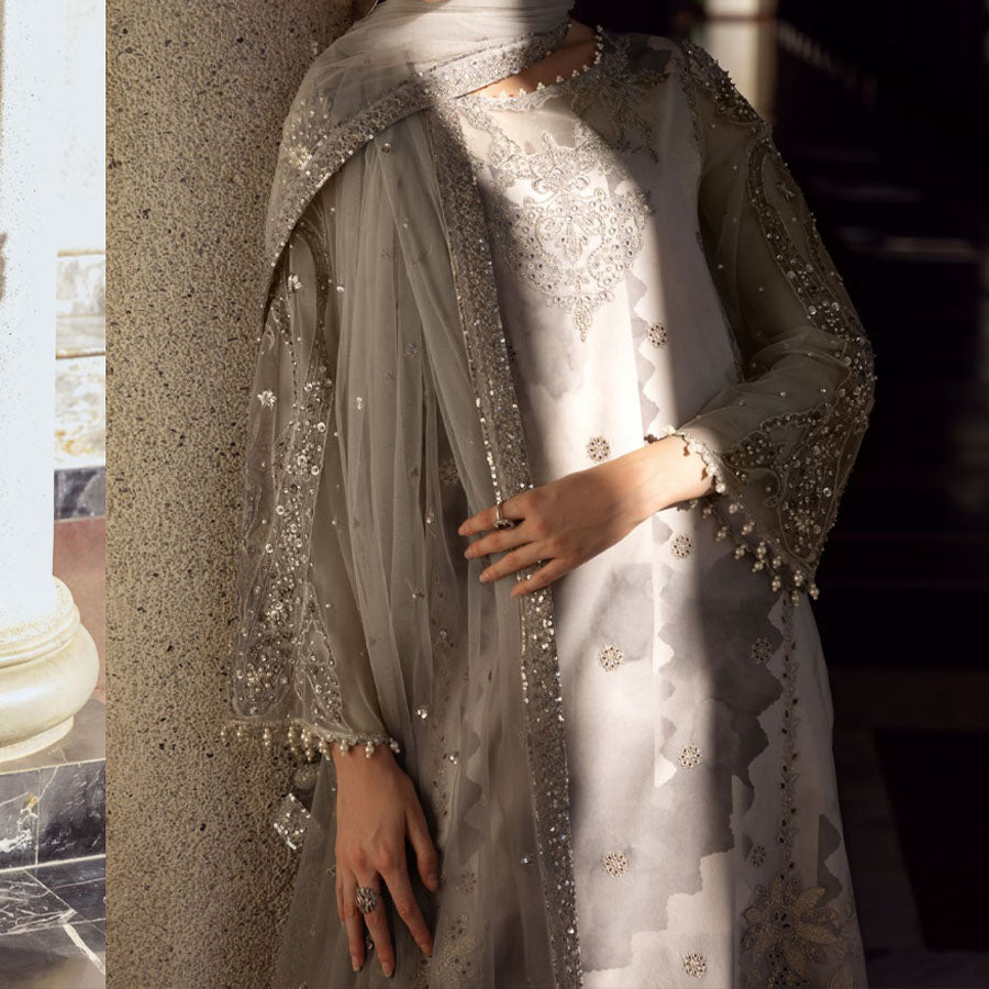 Charizma Festive Unstitched Collection 2025 – Two models wearing elegant embroidered Pakistani suits in pastel blue and golden yellow, featuring intricate handwork, sequins, and delicate embellishments, perfect for Eid celebrations and festive occasions.
