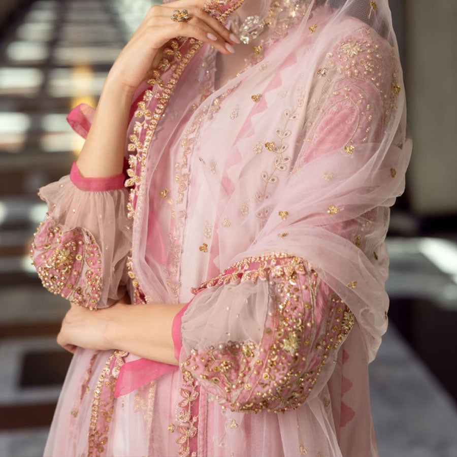 Charizma Festive Unstitched Collection 2025 – Two models wearing elegant embroidered Pakistani suits in pastel blue and golden yellow, featuring intricate handwork, sequins, and delicate embellishments, perfect for Eid celebrations and festive occasions.