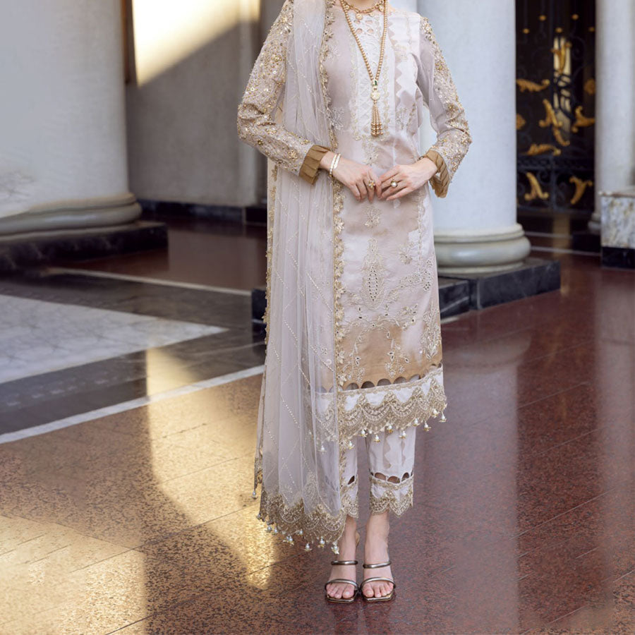 Charizma Festive Unstitched Collection 2025 – Two models wearing elegant embroidered Pakistani suits in pastel blue and golden yellow, featuring intricate handwork, sequins, and delicate embellishments, perfect for Eid celebrations and festive occasions.