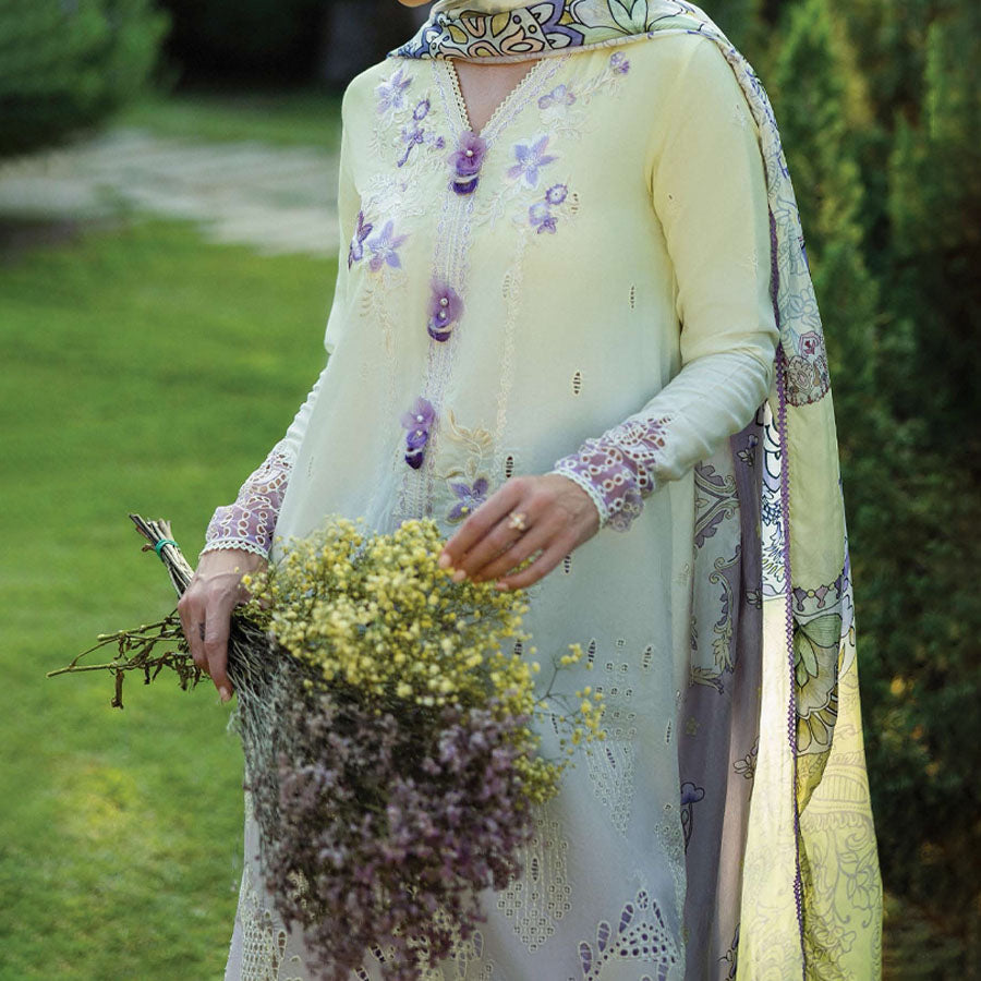 A model wearing a pastel embroidered lawn suit, featuring delicate floral patterns and a matching dupatta, ideal for summer occasions, sitting in a garden setting, showcasing traditional elegance and comfort, wearing a chickenkari embroidered dress.