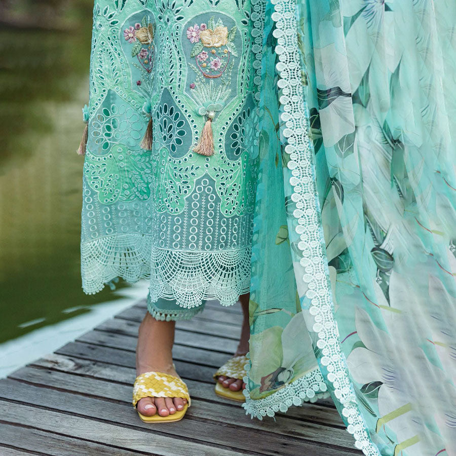 A model wearing a pastel embroidered lawn suit, featuring delicate floral patterns and a matching dupatta, ideal for summer occasions, sitting in a garden setting, showcasing traditional elegance and comfort, wearing a chickenkari embroidered dress.