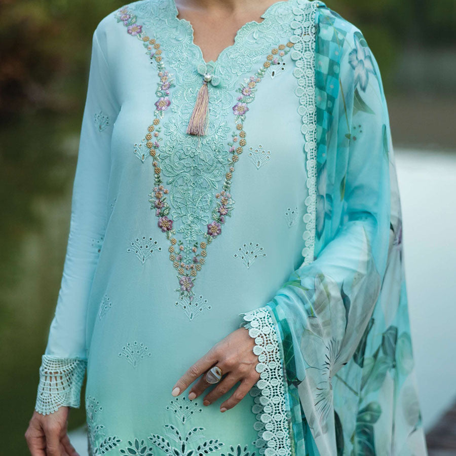 A model wearing a pastel embroidered lawn suit, featuring delicate floral patterns and a matching dupatta, ideal for summer occasions, sitting in a garden setting, showcasing traditional elegance and comfort, wearing a chickenkari embroidered dress.