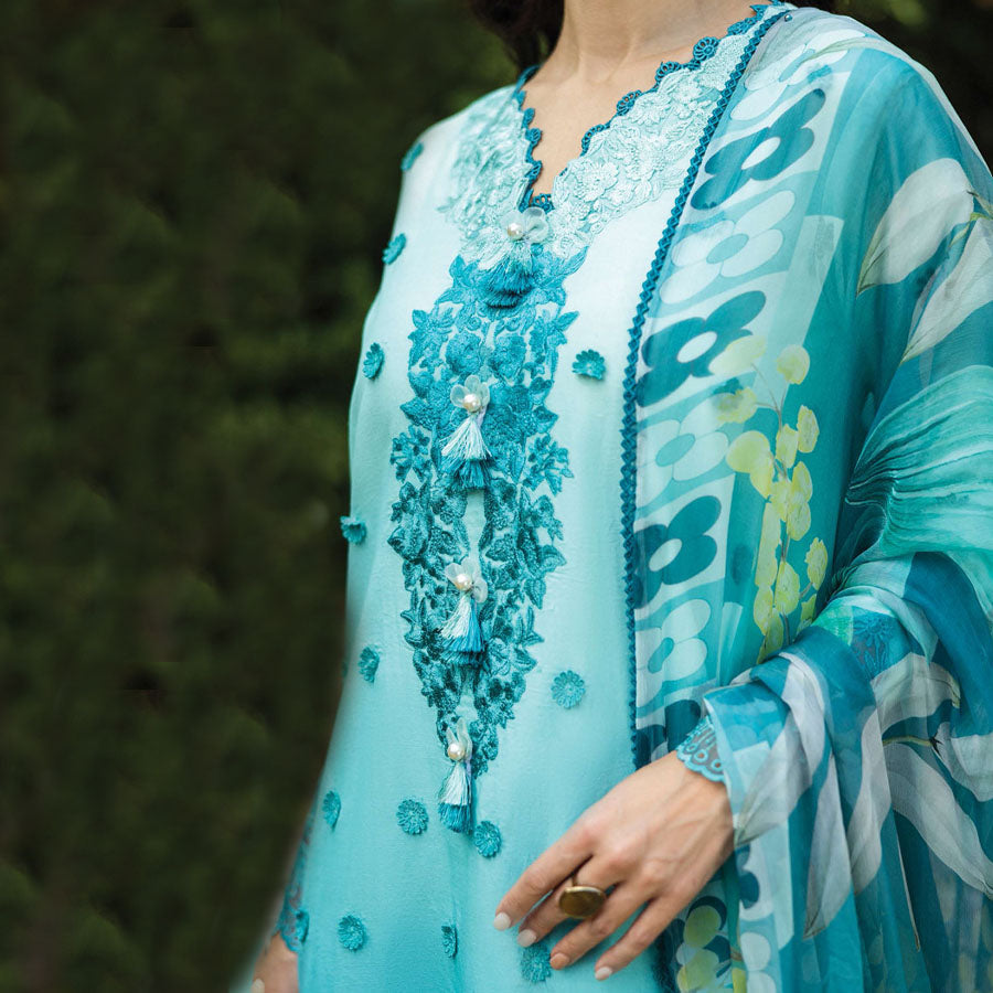 A model wearing a pastel embroidered lawn suit, featuring delicate floral patterns and a matching dupatta, ideal for summer occasions, sitting in a garden setting, showcasing traditional elegance and comfort, wearing a chickenkari embroidered dress.