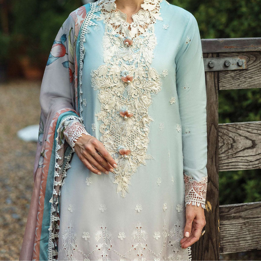 A model wearing a pastel embroidered lawn suit, featuring delicate floral patterns and a matching dupatta, ideal for summer occasions, sitting in a garden setting, showcasing traditional elegance and comfort, wearing a chickenkari embroidered dress.