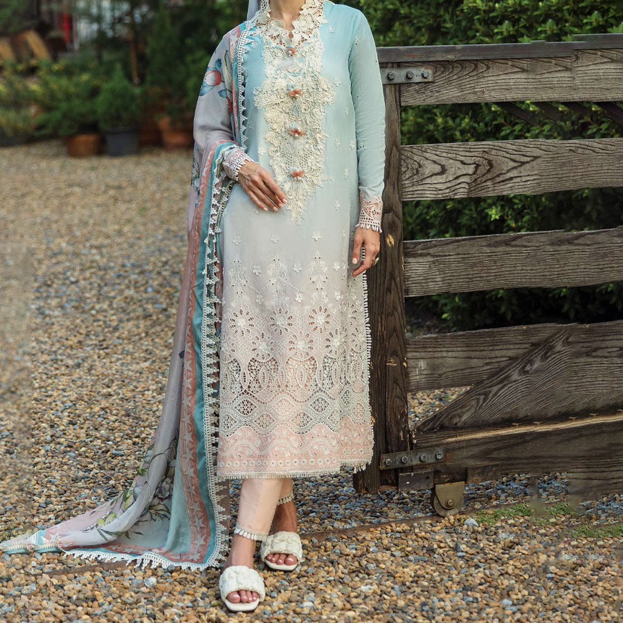 A model wearing a pastel embroidered lawn suit, featuring delicate floral patterns and a matching dupatta, ideal for summer occasions, sitting in a garden setting, showcasing traditional elegance and comfort, wearing a chickenkari embroidered dress.
