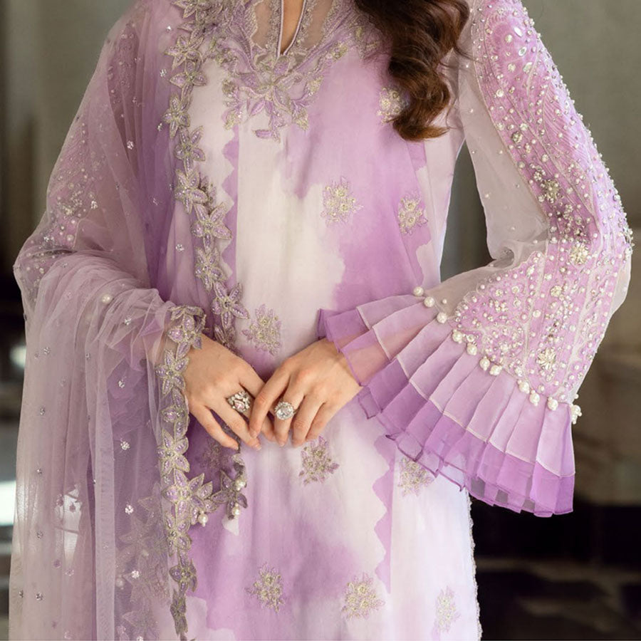 Charizma Festive Unstitched Collection 2025 – Two models wearing elegant embroidered Pakistani suits in pastel blue and golden yellow, featuring intricate handwork, sequins, and delicate embellishments, perfect for Eid celebrations and festive occasions.