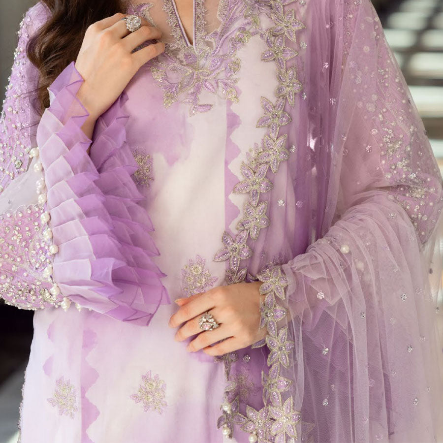 Charizma Festive Unstitched Collection 2025 – Two models wearing elegant embroidered Pakistani suits in pastel blue and golden yellow, featuring intricate handwork, sequins, and delicate embellishments, perfect for Eid celebrations and festive occasions.