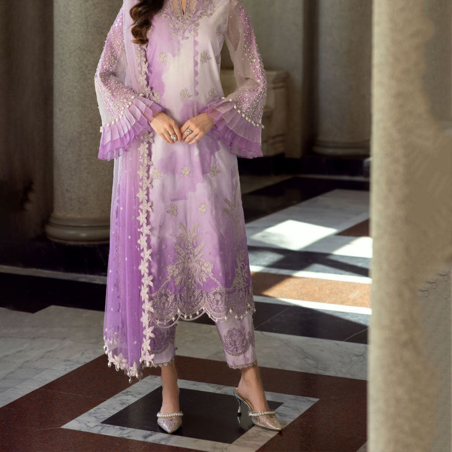 Charizma Festive Unstitched Collection 2025 – Two models wearing elegant embroidered Pakistani suits in pastel blue and golden yellow, featuring intricate handwork, sequins, and delicate embellishments, perfect for Eid celebrations and festive occasions.