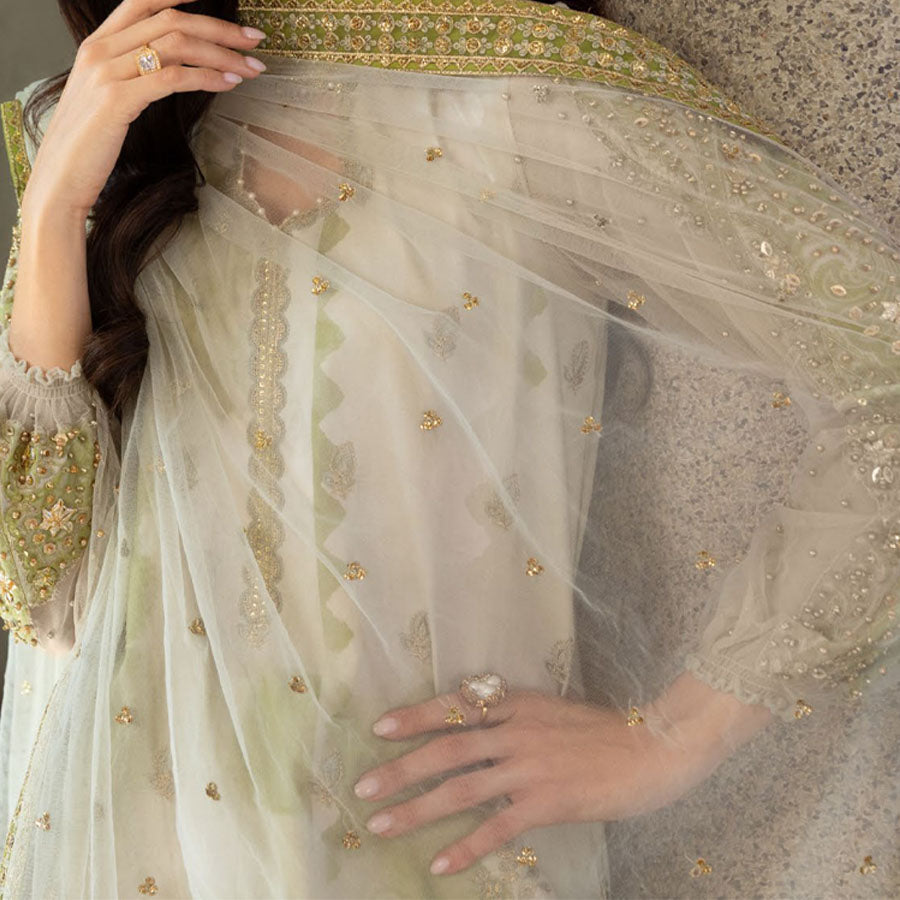 Charizma Festive Unstitched Collection 2025 – Two models wearing elegant embroidered Pakistani suits in pastel blue and golden yellow, featuring intricate handwork, sequins, and delicate embellishments, perfect for Eid celebrations and festive occasions.