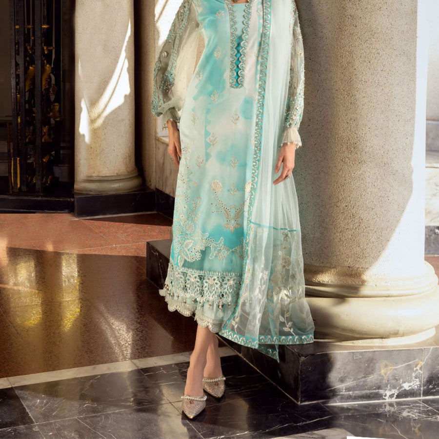 Charizma Festive Unstitched Collection 2025 – Two models wearing elegant embroidered Pakistani suits in pastel blue and golden yellow, featuring intricate handwork, sequins, and delicate embellishments, perfect for Eid celebrations and festive occasions.