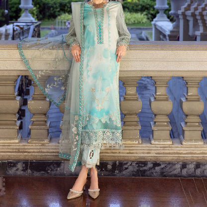 Charizma Festive Unstitched Collection 2025 – Two models wearing elegant embroidered Pakistani suits in pastel blue and golden yellow, featuring intricate handwork, sequins, and delicate embellishments, perfect for Eid celebrations and festive occasions.