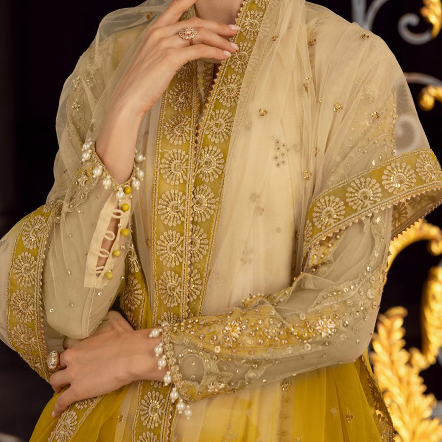 Charizma Festive Unstitched Collection 2025 – Two models wearing elegant embroidered Pakistani suits in pastel blue and golden yellow, featuring intricate handwork, sequins, and delicate embellishments, perfect for Eid celebrations and festive occasions.