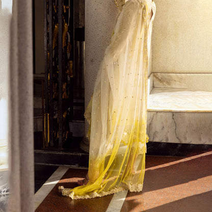 Charizma Festive Unstitched Collection 2025 – Two models wearing elegant embroidered Pakistani suits in pastel blue and golden yellow, featuring intricate handwork, sequins, and delicate embellishments, perfect for Eid celebrations and festive occasions.