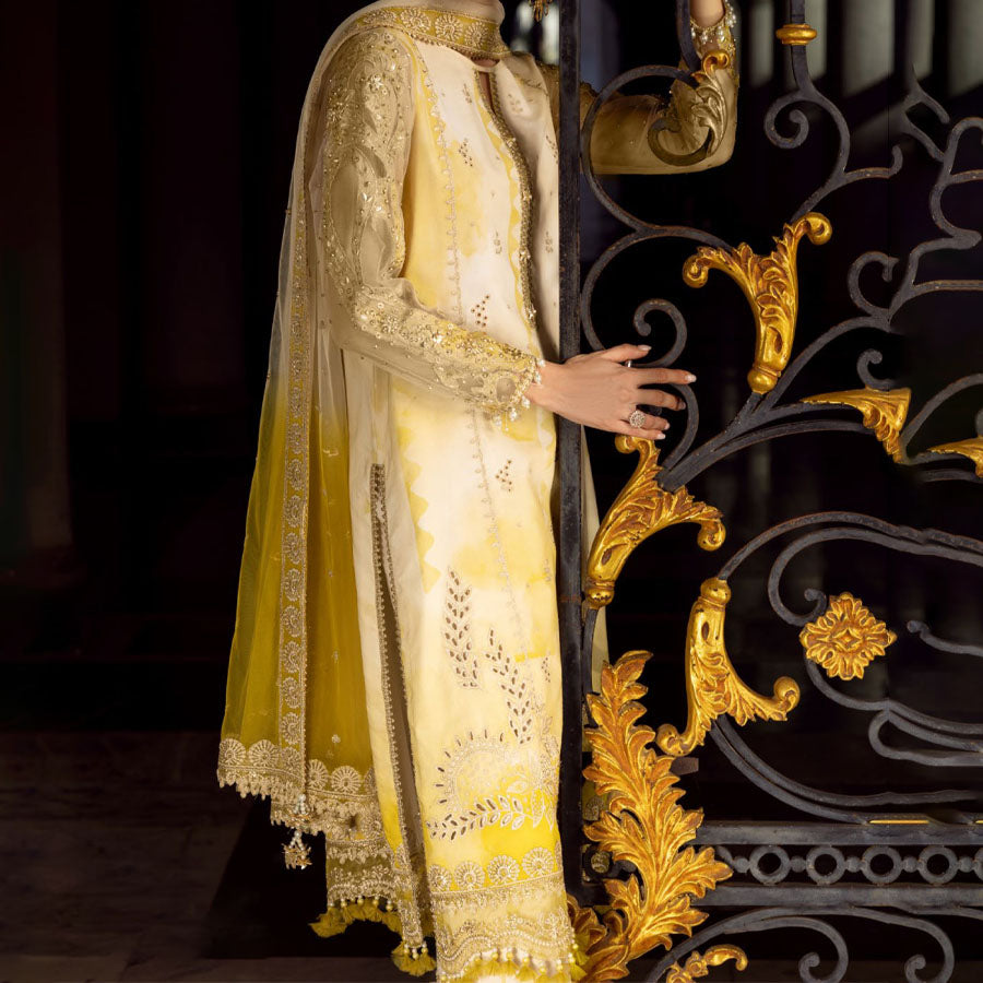 Charizma Festive Unstitched Collection 2025 – Two models wearing elegant embroidered Pakistani suits in pastel blue and golden yellow, featuring intricate handwork, sequins, and delicate embellishments, perfect for Eid celebrations and festive occasions.