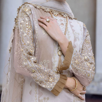 Charizma Festive Unstitched Collection 2025 – Two models wearing elegant embroidered Pakistani suits in pastel blue and golden yellow, featuring intricate handwork, sequins, and delicate embellishments, perfect for Eid celebrations and festive occasions.