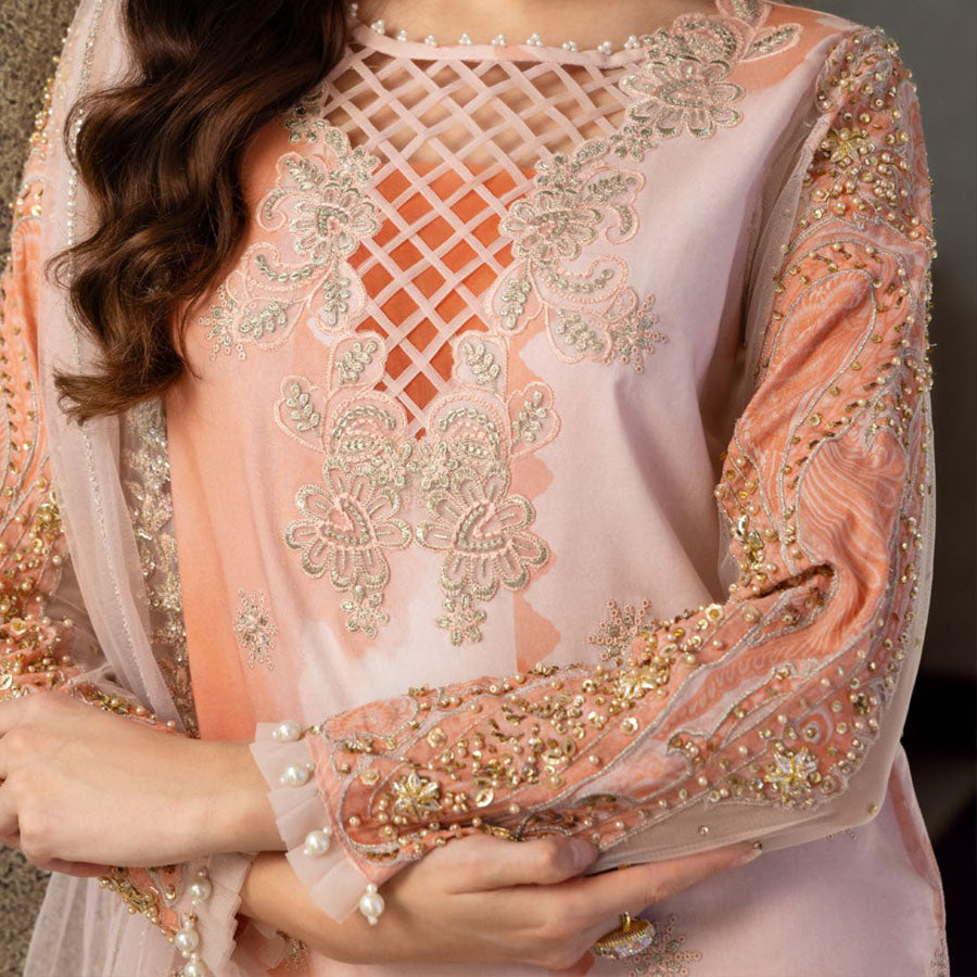 Charizma Festive Unstitched Collection 2025 – Two models wearing elegant embroidered Pakistani suits in pastel blue and golden yellow, featuring intricate handwork, sequins, and delicate embellishments, perfect for Eid celebrations and festive occasions.