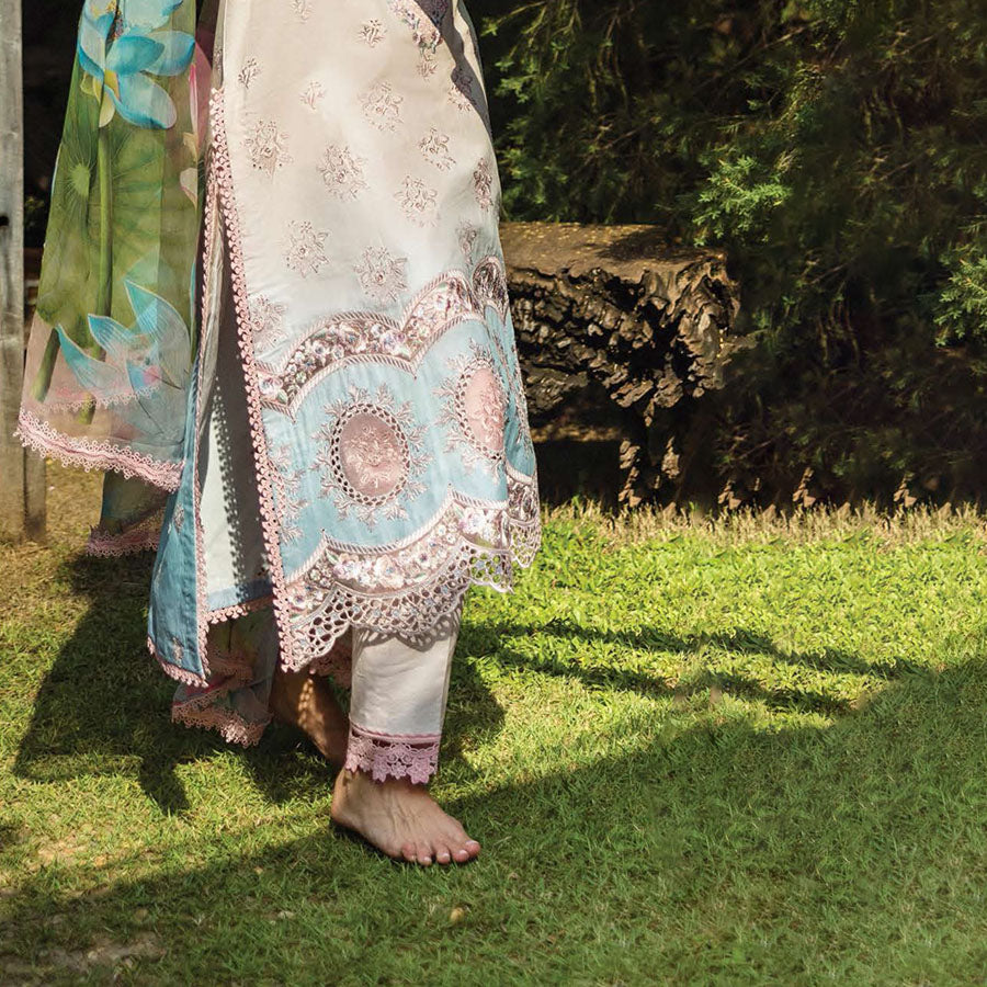 A model wearing a pastel embroidered lawn suit, featuring delicate floral patterns and a matching dupatta, ideal for summer occasions, sitting in a garden setting, showcasing traditional elegance and comfort, wearing a chickenkari embroidered dress.