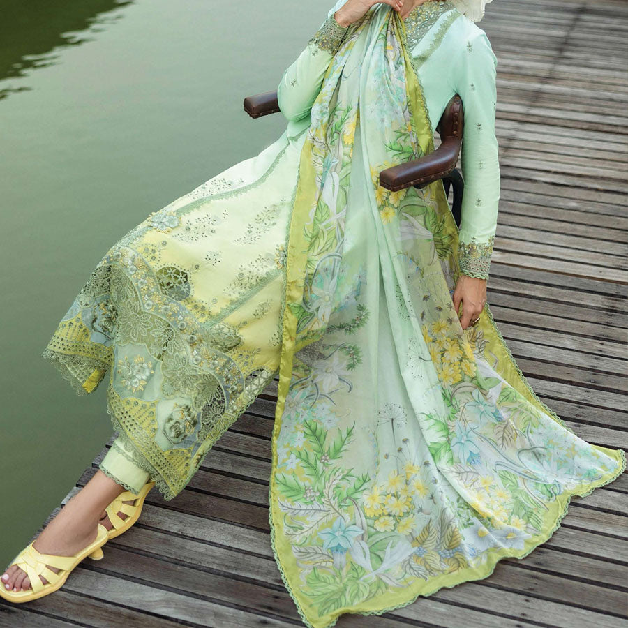 A model wearing a pastel embroidered lawn suit, featuring delicate floral patterns and a matching dupatta, ideal for summer occasions, sitting in a garden setting, showcasing traditional elegance and comfort, wearing a chickenkari embroidered dress.